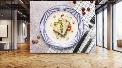 Plate of delicious sea bass fish on light background Wall mural