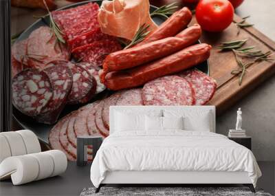 Plate with assortment of delicious deli meats on wooden board Wall mural