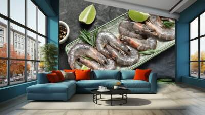 Plate with fresh raw shrimps, lime and rosemary on grey background Wall mural