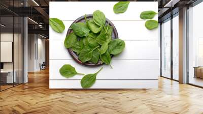 Plate with fresh spinach on white table Wall mural