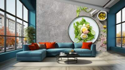 Plate with healthy salad with egg on grey background Wall mural