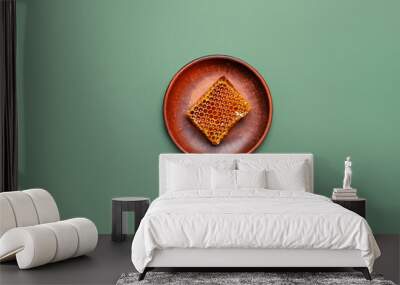 Plate with honey on color background Wall mural