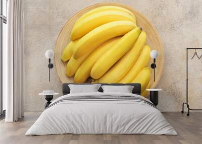 Plate with ripe bananas on light background Wall mural