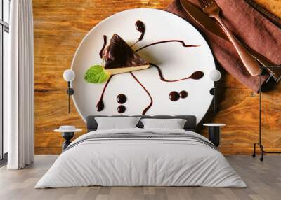 Plate with slice of tasty Basque burnt cheesecake on table Wall mural