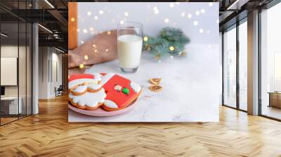 Plate with tasty Christmas cookies and glass of milk on table Wall mural