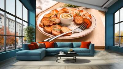 Plate with tasty cooked sweet potato and sauce on table Wall mural