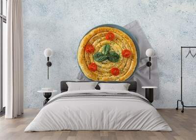 Plate with tasty spinach pie on light background Wall mural