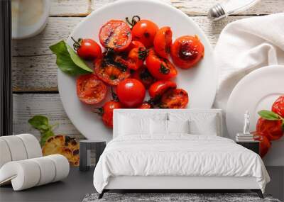 Plates with tasty grilled tomatoes and basil on white wooden background Wall mural