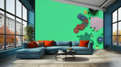 poker chips, pot with coins, cards and clover on green background. st. patrick's day celebration Wall mural