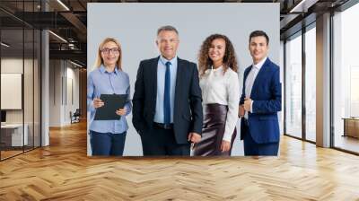 Portrait of business people on grey background Wall mural