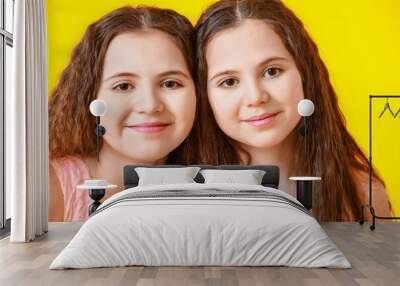 Portrait of cute twin girls on color background Wall mural