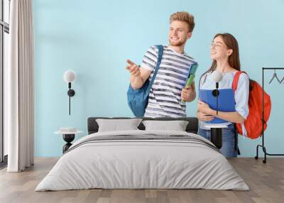 Portrait of female and male students on color background Wall mural