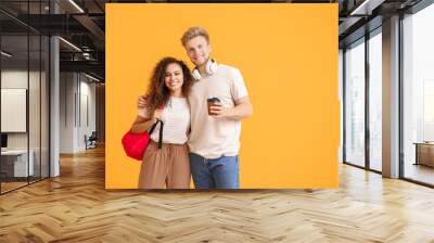 Portrait of female and male students on color background Wall mural