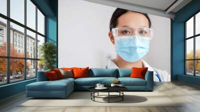 Portrait of female Asian doctor wearing medical mask in clinic Wall mural