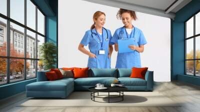 Portrait of female doctors on light background Wall mural