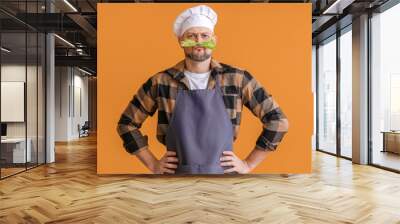 Portrait of funny male chef on color background Wall mural