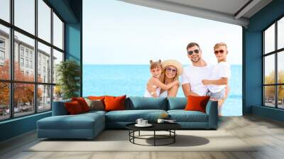 Portrait of happy family on sea beach Wall mural