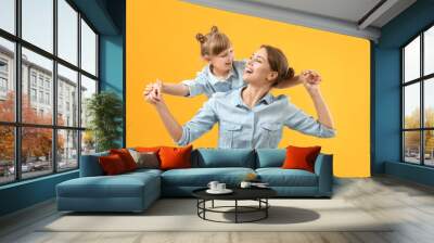 Portrait of happy mother and daughter on color background Wall mural