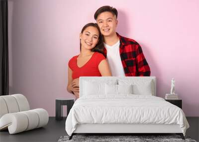 Portrait of happy young Asian couple on color background Wall mural