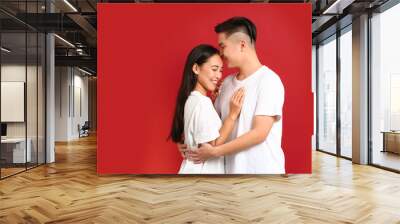 Portrait of happy young Asian couple on color background Wall mural