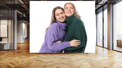 Portrait of happy young sisters on white background Wall mural