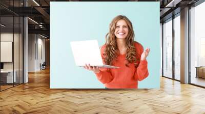 Portrait of happy young woman with laptop on color background Wall mural