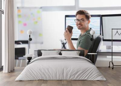 Portrait of male programmer in office Wall mural