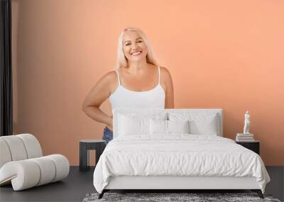 Portrait of mature body positive woman on color background Wall mural