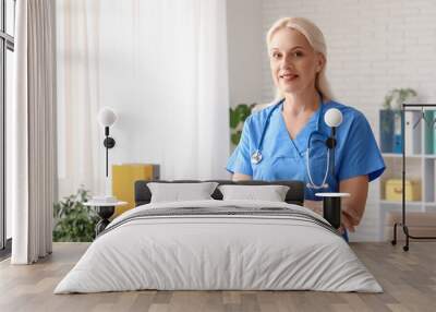 Portrait of mature female doctor in clinic Wall mural