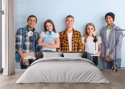 Portrait of young students on color background Wall mural