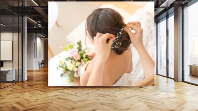 Professional hairdresser working with young bride at home Wall mural