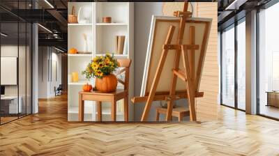 Pumpkins with autumn flowers and easel in living room Wall mural