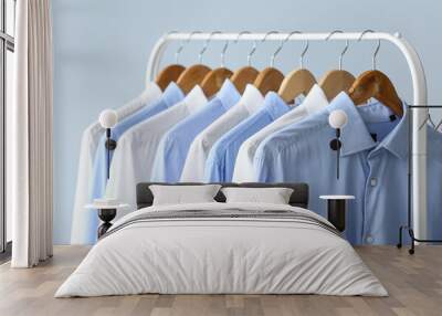 Rack with clean shirts on grey background Wall mural