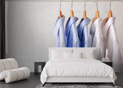 Rack with clothes after dry-cleaning on light background Wall mural