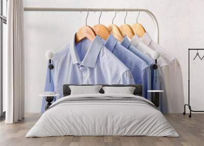 Rack with clothes after dry-cleaning on light background Wall mural