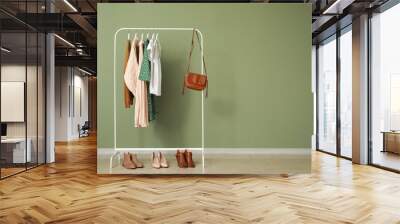 Rack with stylish clothes near color wall Wall mural