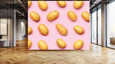 Raw potatoes on pink background Wall mural