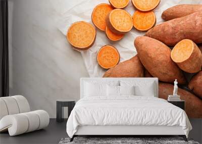 Raw sweet potato on light background Wall mural