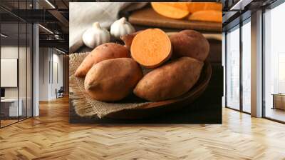 Raw sweet potato on wooden table Wall mural