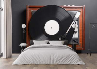 Record player with vinyl disc on dark background Wall mural