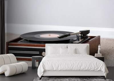 Record player with vinyl disc on floor in room Wall mural