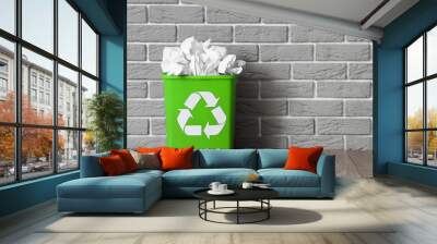 Recycling bin with paper near grey brick wall. Recycle concept Wall mural