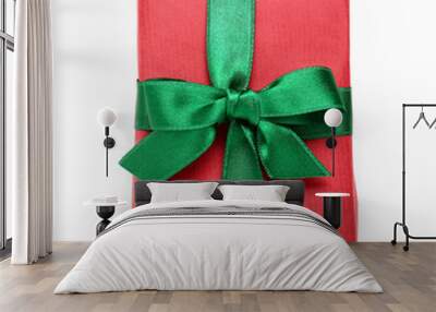 Red Christmas gift box with green ribbon on white background Wall mural