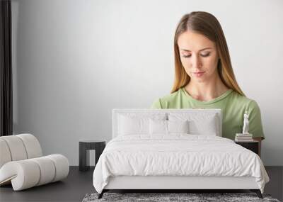 Religious young woman praying on white background Wall mural