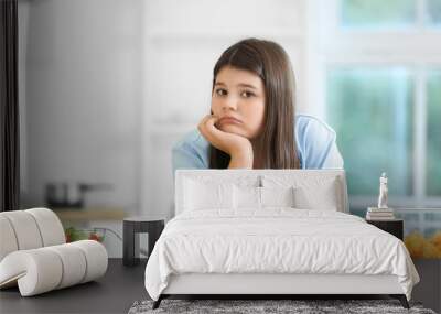 Sad overweight girl with healthy and unhealthy food in kitchen Wall mural