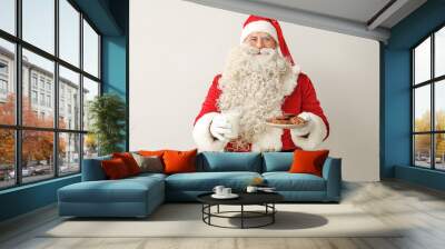 Santa Claus with glass of milk and tasty cookies on white background Wall mural