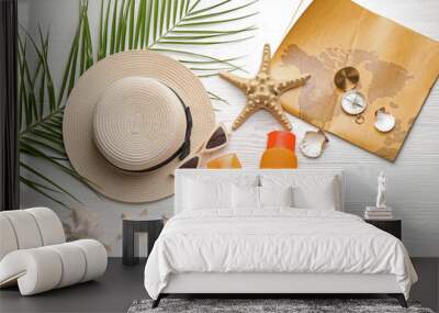 Set of beach accessories with map and compass on white wooden background Wall mural