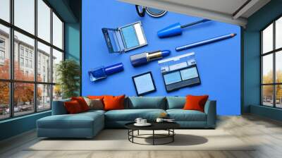 Set of blue makeup cosmetics on color background Wall mural