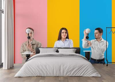 Set of different people rolling up sleeves on color background Wall mural