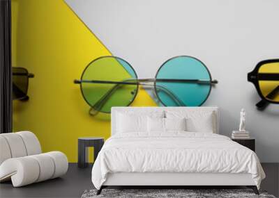 Set of different stylish sunglasses on color background Wall mural